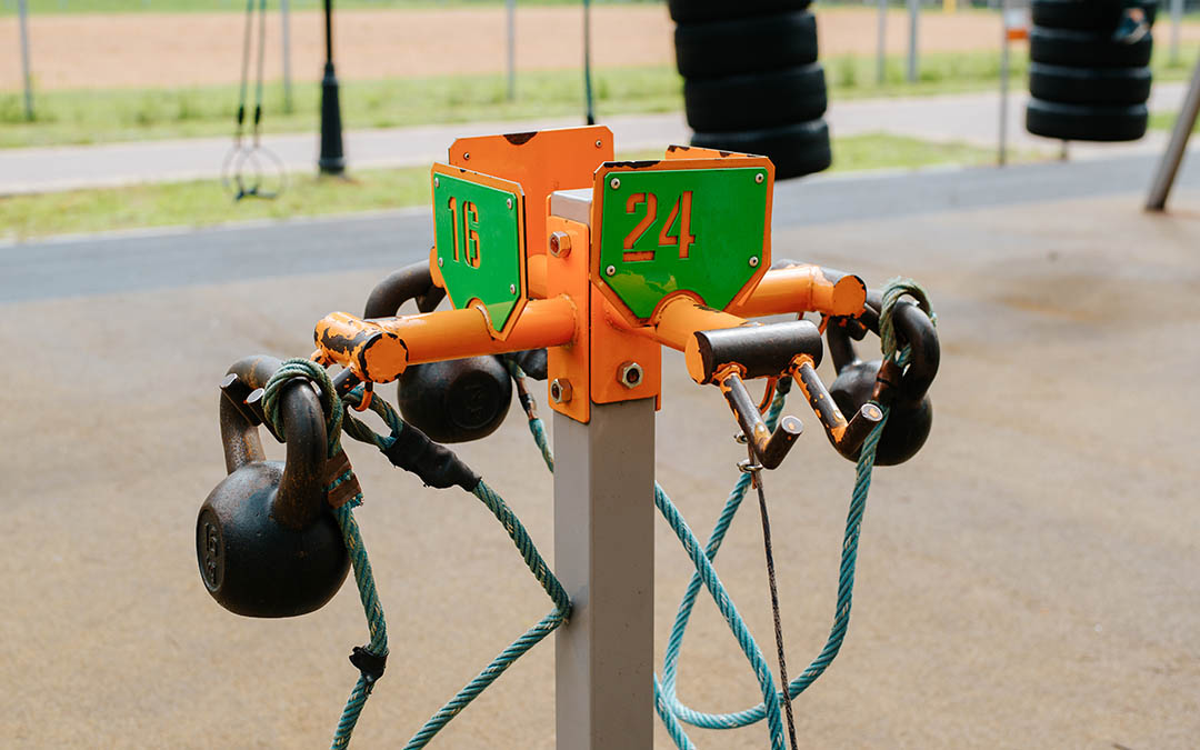Set of kettlebells for weightlifting training on sports ground in park, outdoors. Workout and bodybuilding concept
